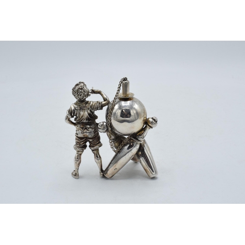 305 - Novelty silver plated table lighter in the form of a boy with bowling equipment, 9.5cm tall.