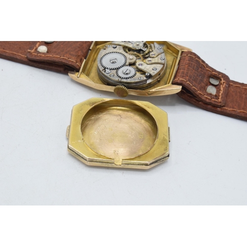 358 - 9ct gold gentleman's wristwatch on leather strap, 26mm wide. In ticking order.