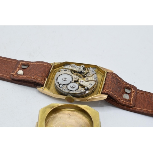 358 - 9ct gold gentleman's wristwatch on leather strap, 26mm wide. In ticking order.