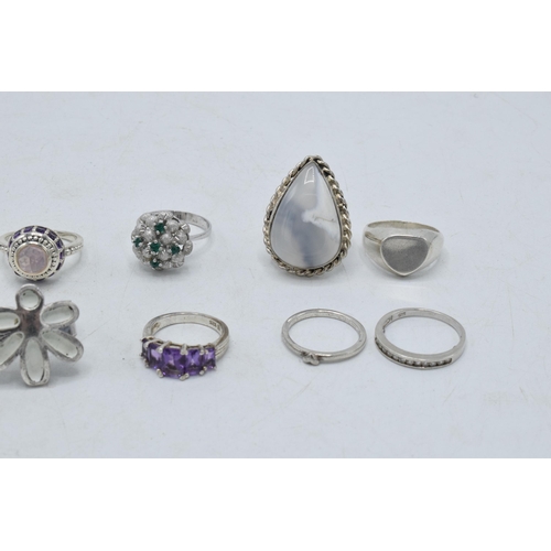 362 - A collection of silver rings of varying forms and sizes, 43.8 grams in total, 1 ring - white flower ... 