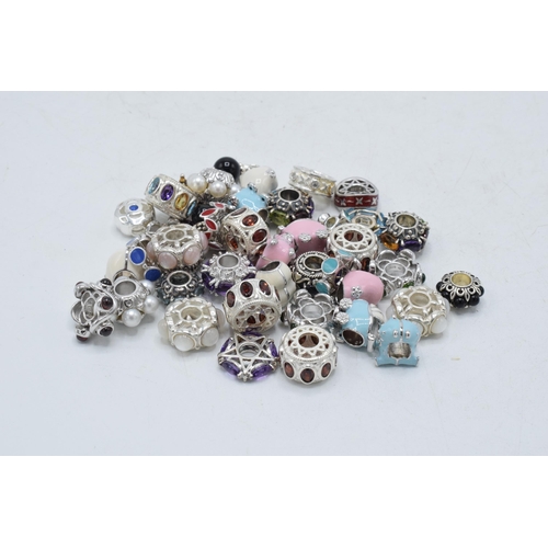 365 - A large collection of modern silver charms, 124.8 grams (Qty).