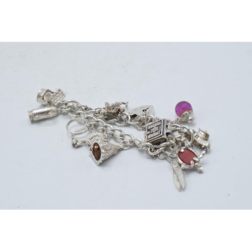 368 - Silver charm bracelet to include teapot, scissors and others, 49.1 grams.