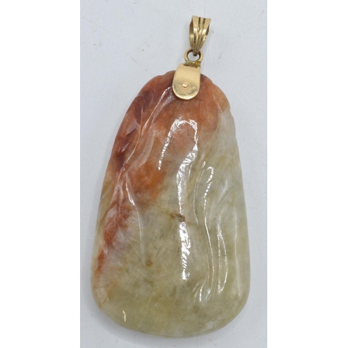 436 - Oriental soapstone pendant set on 14ct gold mount and loop, 5cm long.