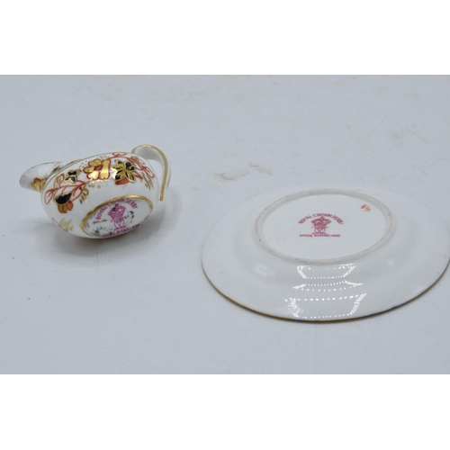 78 - Miniature Royal Crown Derby Imari creamer and 6.5cm diameter plate (2).