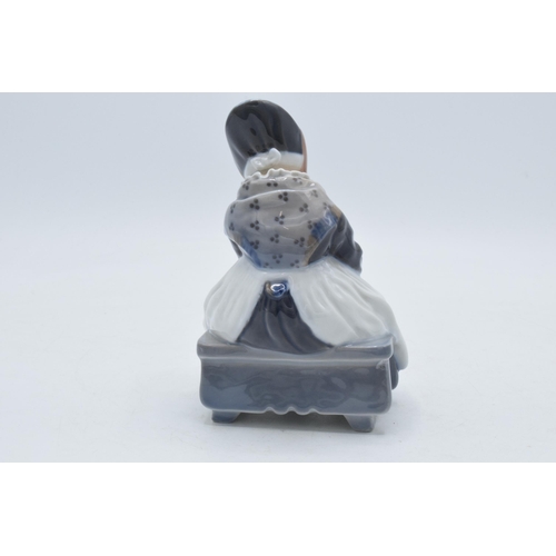 87 - Royal Copenhagen porcelain figure of a girl  seated knitting a scarf 1314, with printed and painted ... 