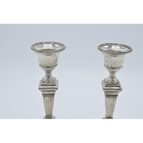 317 - A pair of Victorian silver candlesticks with loaded bases, hallmarks rubbed thought to be London 189... 