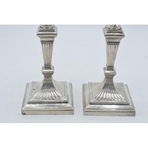 317 - A pair of Victorian silver candlesticks with loaded bases, hallmarks rubbed thought to be London 189... 