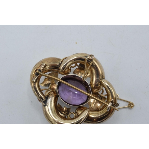 434 - Victorian gold amethyst brooch with raised floral decoration, 7.4 grams, 4cm wide.