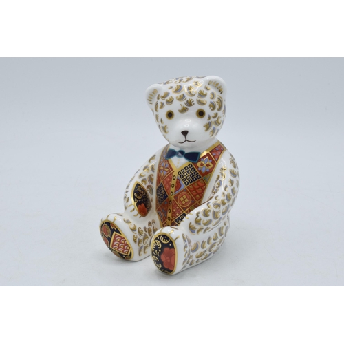 64 - Royal Crown Derby paperweight, Teddy Bear, 12cm, with blue bow tie and silver stopper.