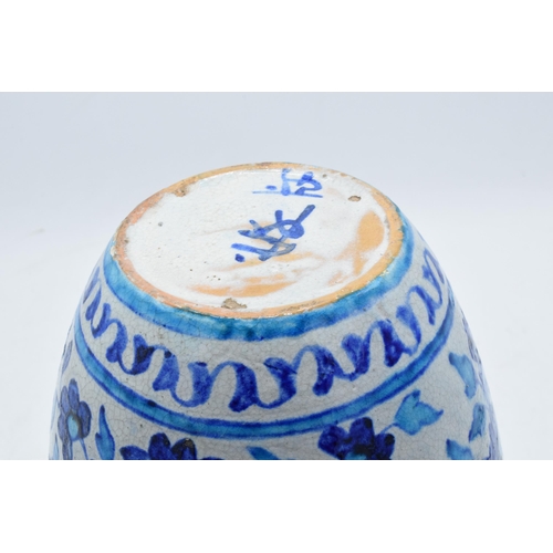 47 - A 19th century blue and white pottery Iznik or similar vase with crackle glaze effect. 25cm tall.