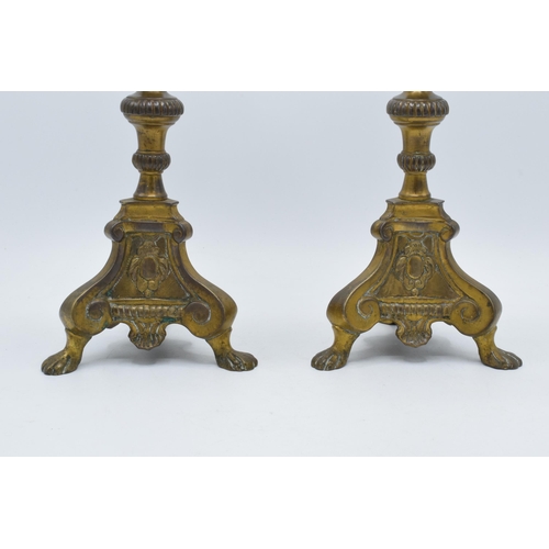 247 - A pair of late 19th century Ecclesiastical brass baluster form candlesticks with each terminating on... 