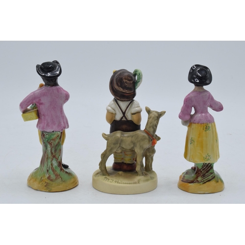 50B - Goebel / Hummel figure together with a pair of Staffordshire Ware Meissen-style figures (3).