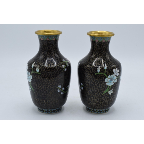 241 - A pair of Japanese cloisonne vases with floral decoration on a black background, 15.5cm tall,