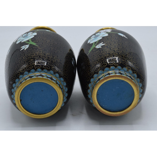 241 - A pair of Japanese cloisonne vases with floral decoration on a black background, 15.5cm tall,