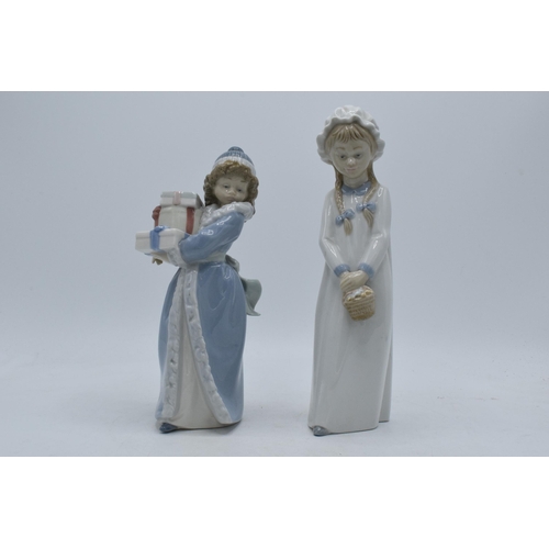 140 - A pair of Nao by Lladro figures of girls in traditional clothing, 26cm tallest.