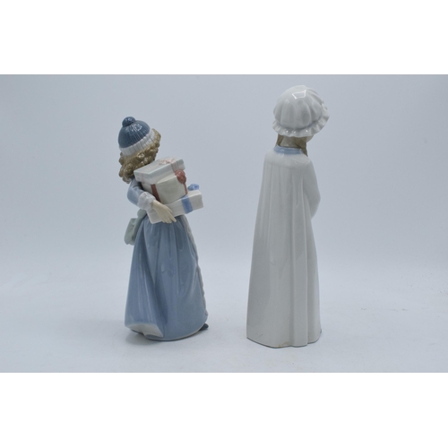 140 - A pair of Nao by Lladro figures of girls in traditional clothing, 26cm tallest.