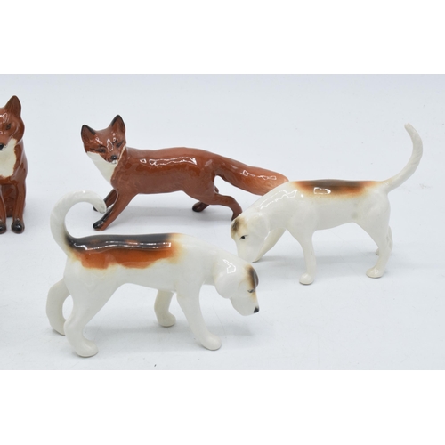 158 - A collection of Beswick to include 4 foxhounds and 2 foxes (6).