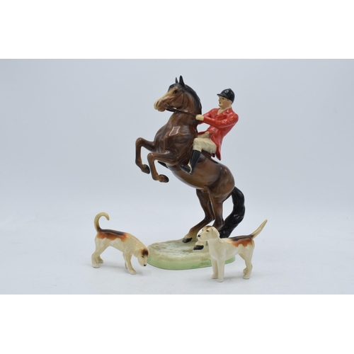 162 - Beswick rearing huntsman with red jacket 868 together with 2 foxhounds (3).