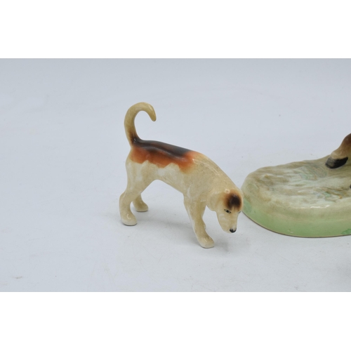 162 - Beswick rearing huntsman with red jacket 868 together with 2 foxhounds (3).