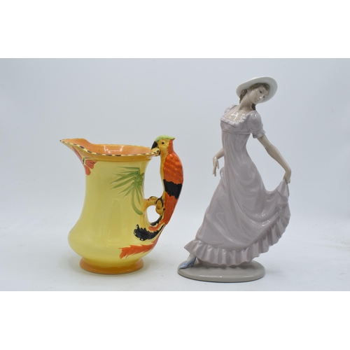 22 - Burleigh Art-Deco jug with cockatoo handle together with Nao figure of a girl wearing a bonnet (2).