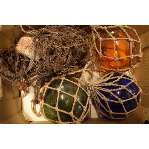 271 - A collection of glass buoy-style items in rope nets together with a net (4).