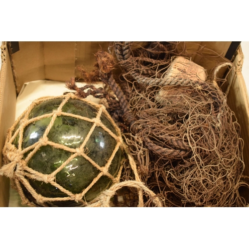 271 - A collection of glass buoy-style items in rope nets together with a net (4).