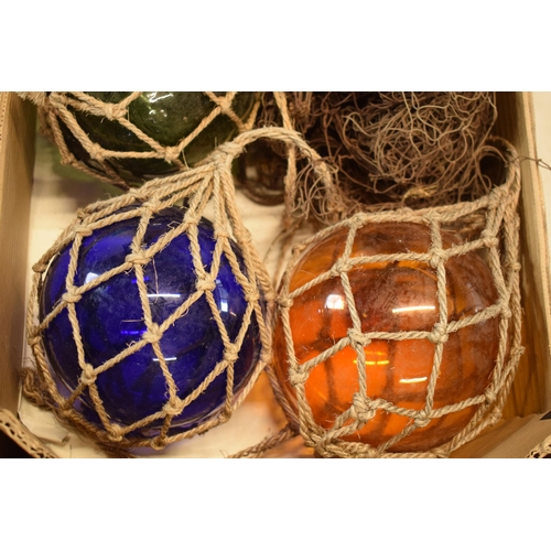 271 - A collection of glass buoy-style items in rope nets together with a net (4).