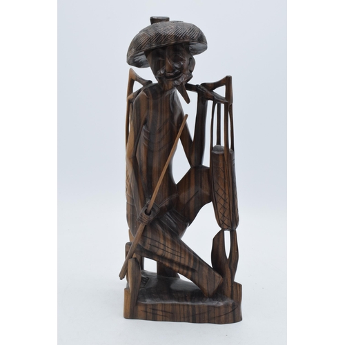 279 - 20th century Eastern wooden tribal-style carving of a water carrier / fisherman, 31cm, signed 'REDIG... 