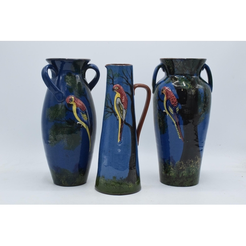 37 - A trio of Longpark Torquay Ware vases with each decorated with a parrot amongst tree branches, one v... 