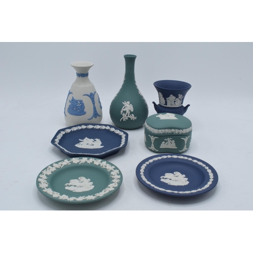 76 - A collection of Wedgwood Jasperware to include vases, a trinket and pin dishes of varying colours an... 