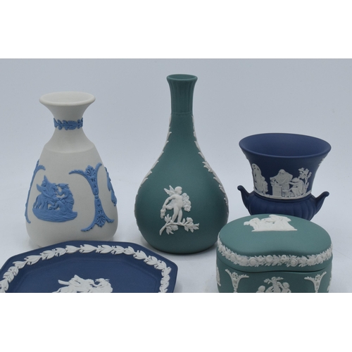 76 - A collection of Wedgwood Jasperware to include vases, a trinket and pin dishes of varying colours an... 