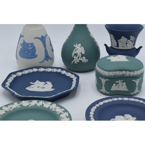 76 - A collection of Wedgwood Jasperware to include vases, a trinket and pin dishes of varying colours an... 