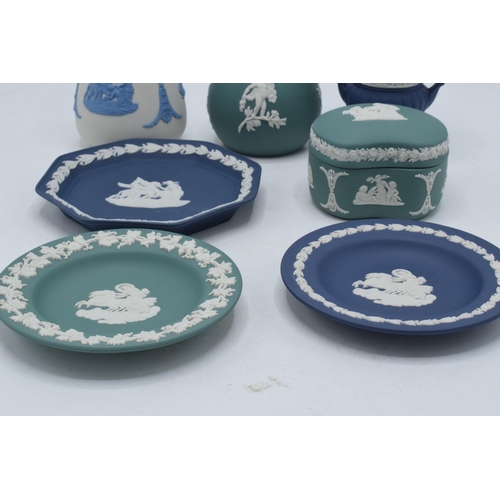 76 - A collection of Wedgwood Jasperware to include vases, a trinket and pin dishes of varying colours an... 