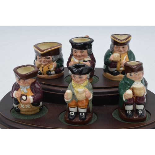 170 - Royal Doulton Tiny Tobies set of Toby jugs together with wooden stand, all matching number (7).