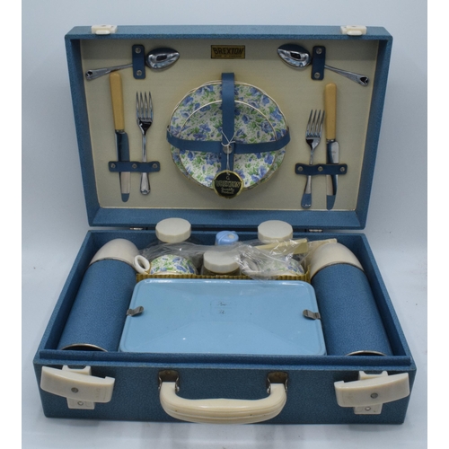 317 - A 1960s/70s Brexton picnic set in blue case to include flasks, cutlery and crockery (one side missin... 