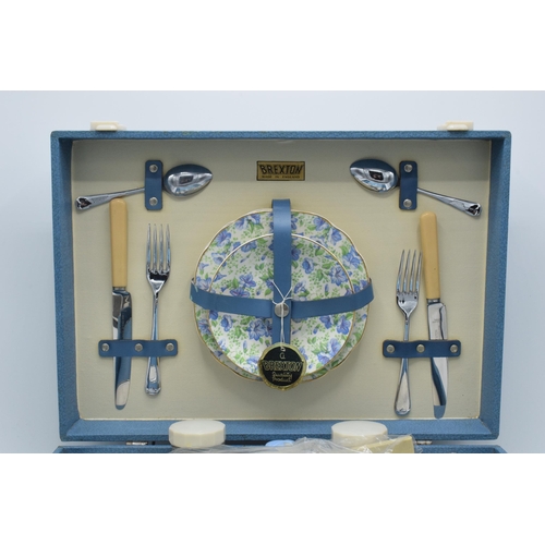 317 - A 1960s/70s Brexton picnic set in blue case to include flasks, cutlery and crockery (one side missin... 