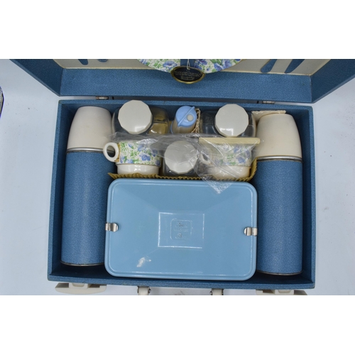 317 - A 1960s/70s Brexton picnic set in blue case to include flasks, cutlery and crockery (one side missin... 