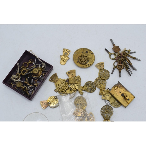 324 - A collection of gilt-brass pocket watch spares / parts to include pocket watch balance cocks, keys a... 