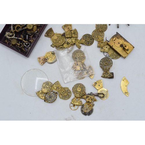 324 - A collection of gilt-brass pocket watch spares / parts to include pocket watch balance cocks, keys a... 