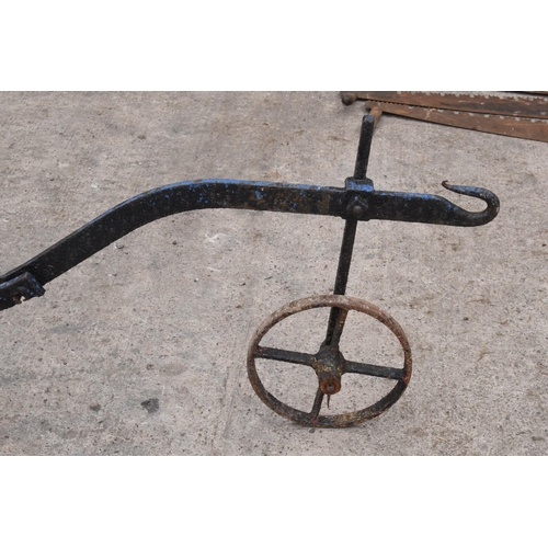 326 - Antique cast-metal garden plough, 260cm long. Working wheel.