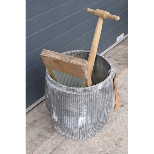 327 - A vintage galvanised dolly tub, 52cm tall, together with accessories to include wash board, wooden p... 