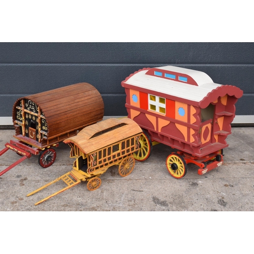 331 - A trio of wooden bow-top Romany caravan models, largest 42cm long.