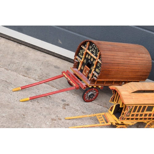 331 - A trio of wooden bow-top Romany caravan models, largest 42cm long.