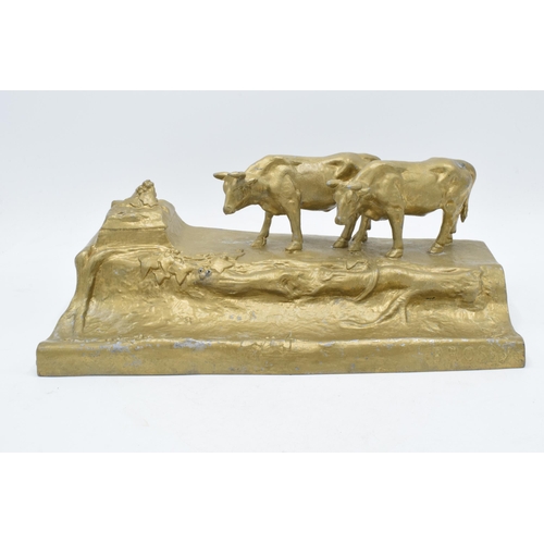 341 - A cast metal inkwell in the form of an mountainous cattle scene, 32cm long.