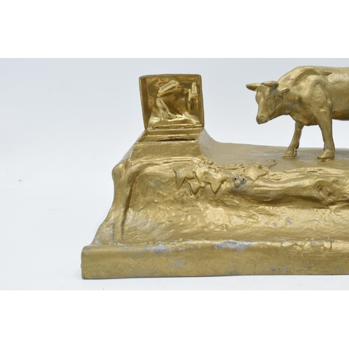 341 - A cast metal inkwell in the form of an mountainous cattle scene, 32cm long.