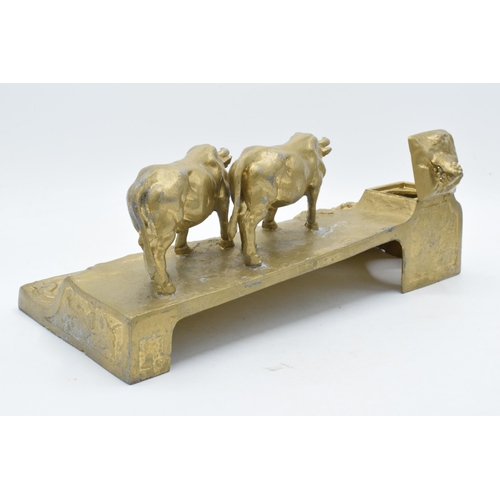 341 - A cast metal inkwell in the form of an mountainous cattle scene, 32cm long.