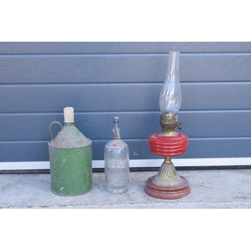 348 - Early to mid 20th century brass oil lamp with red glass reservoir together with a vintage fuel can a... 