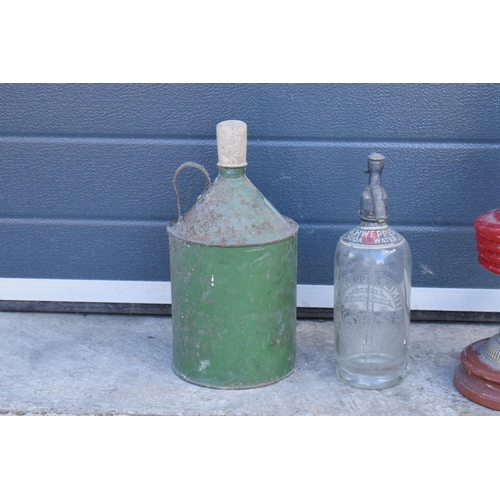 348 - Early to mid 20th century brass oil lamp with red glass reservoir together with a vintage fuel can a... 