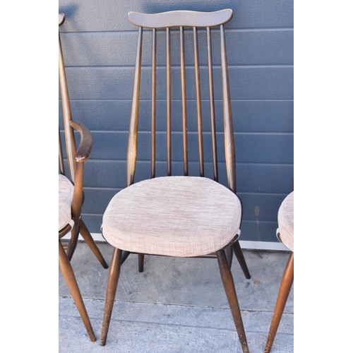 373 - A set of 4 mid century Ercol spindle-back chairs to include 2 arm chairs (4). 97cm tall.