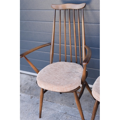 373 - A set of 4 mid century Ercol spindle-back chairs to include 2 arm chairs (4). 97cm tall.